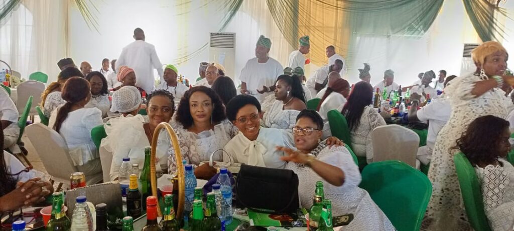 OREOSA92 members dressed in white seated at tables during an indoor reception